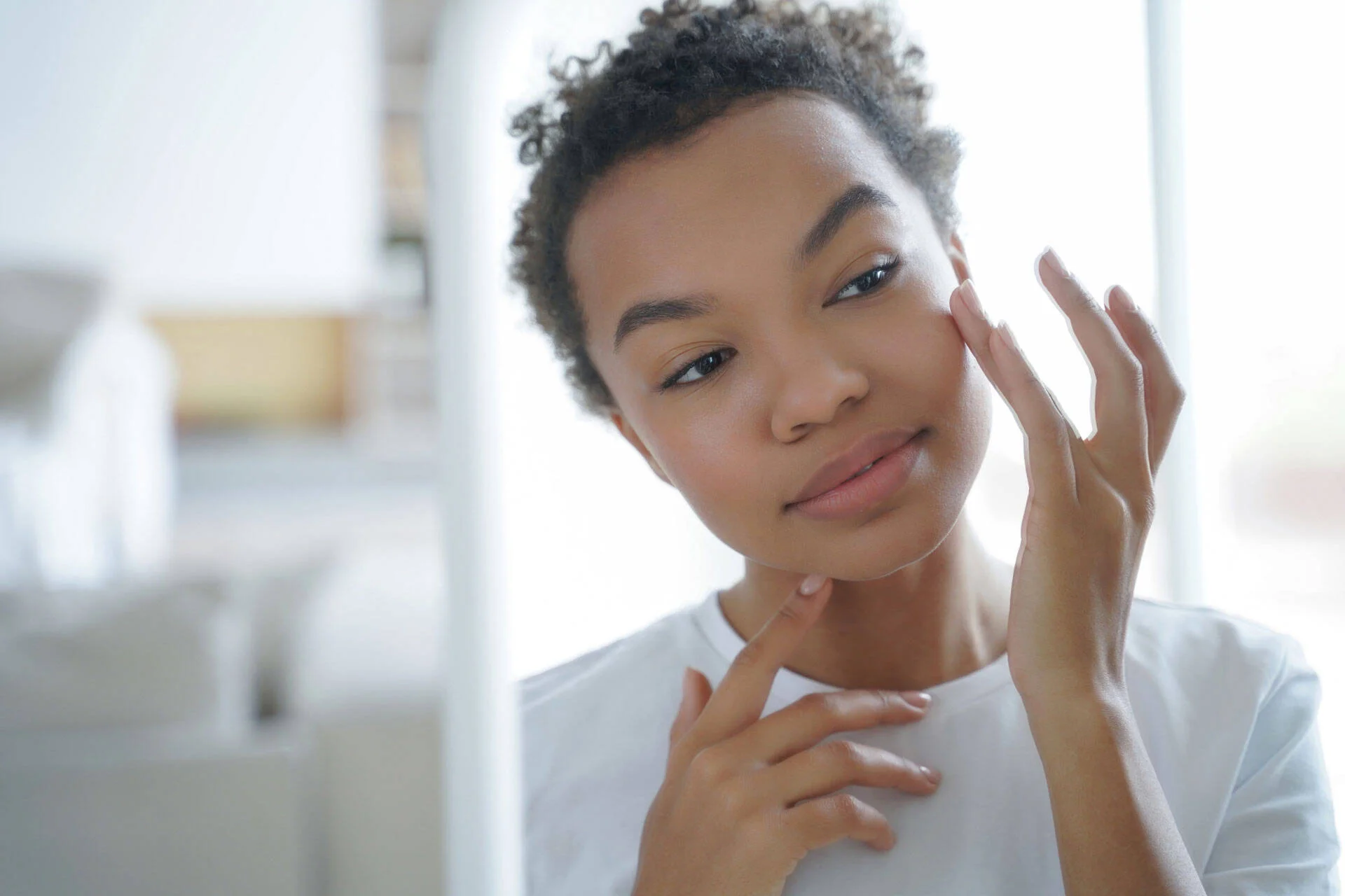 Woman touching her face, checking her skin